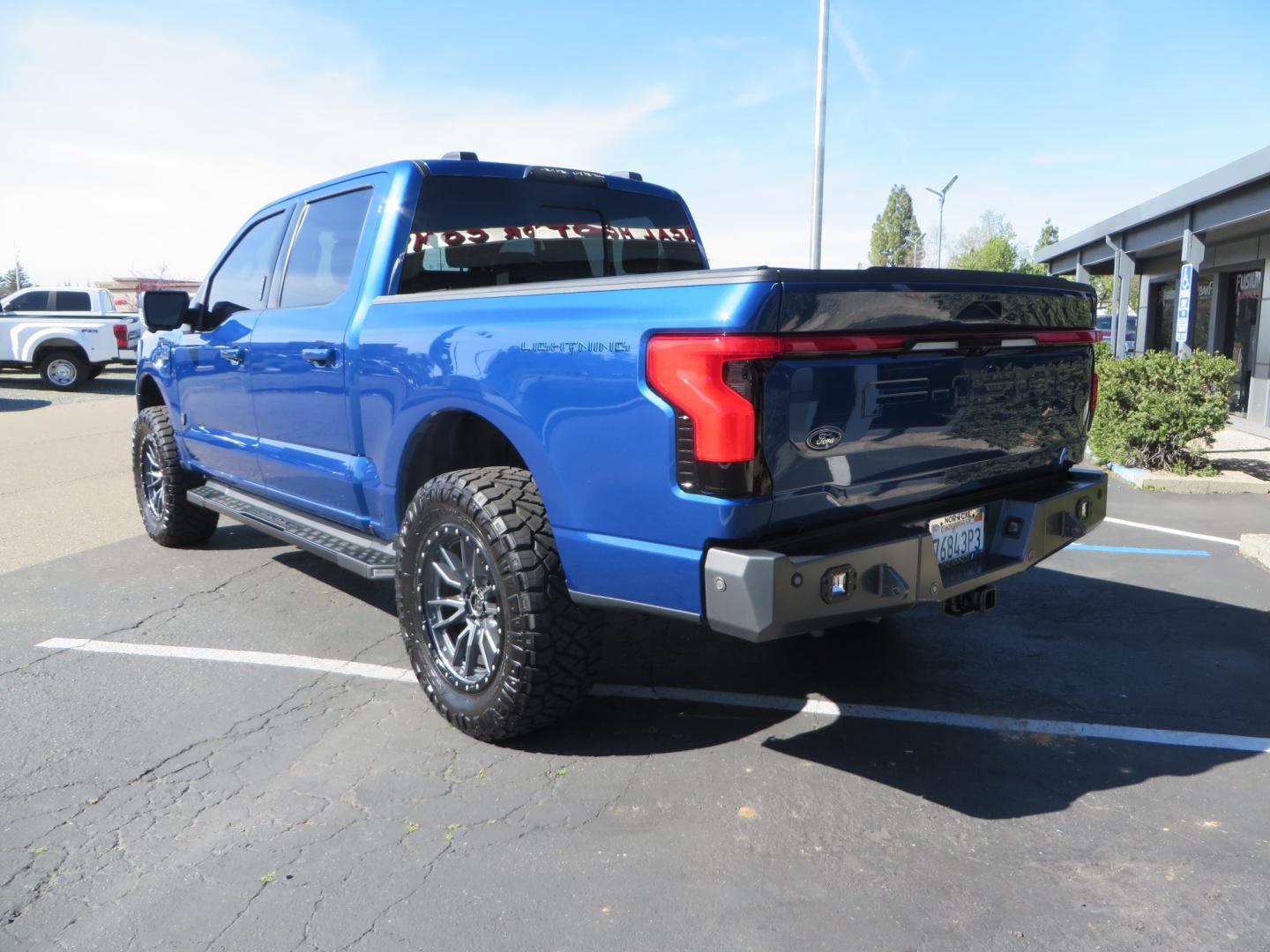 2022 BLUE /BLACK Ford F-150 Lariat Crew Cab 4WD (1FT6W1EV6NW) , located at 2630 Grass Valley Highway, Auburn, CA, 95603, (530) 508-5100, 38.937893, -121.095482 - Tired of gas prices and still want to look cool? Check out this Ford Lightning featuring a RC level kit, Nitto Ridge Grappler tires, Fuel Rebel wheels, Sinister front and rear bumpers, Baja Designs leds, Rigid Industries Leds, Bakflip F1, and window tint. - Photo#6